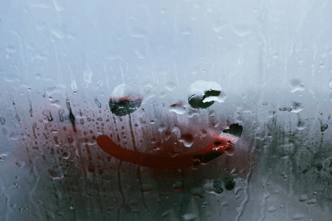 A smiley face drawn in fog symbolizes 10 PUTO car wash beliefs about cleanliness and luck.