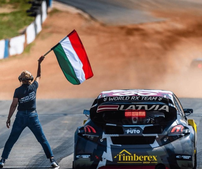 Latvian motorsport team PUTO in a race with a starting flag.