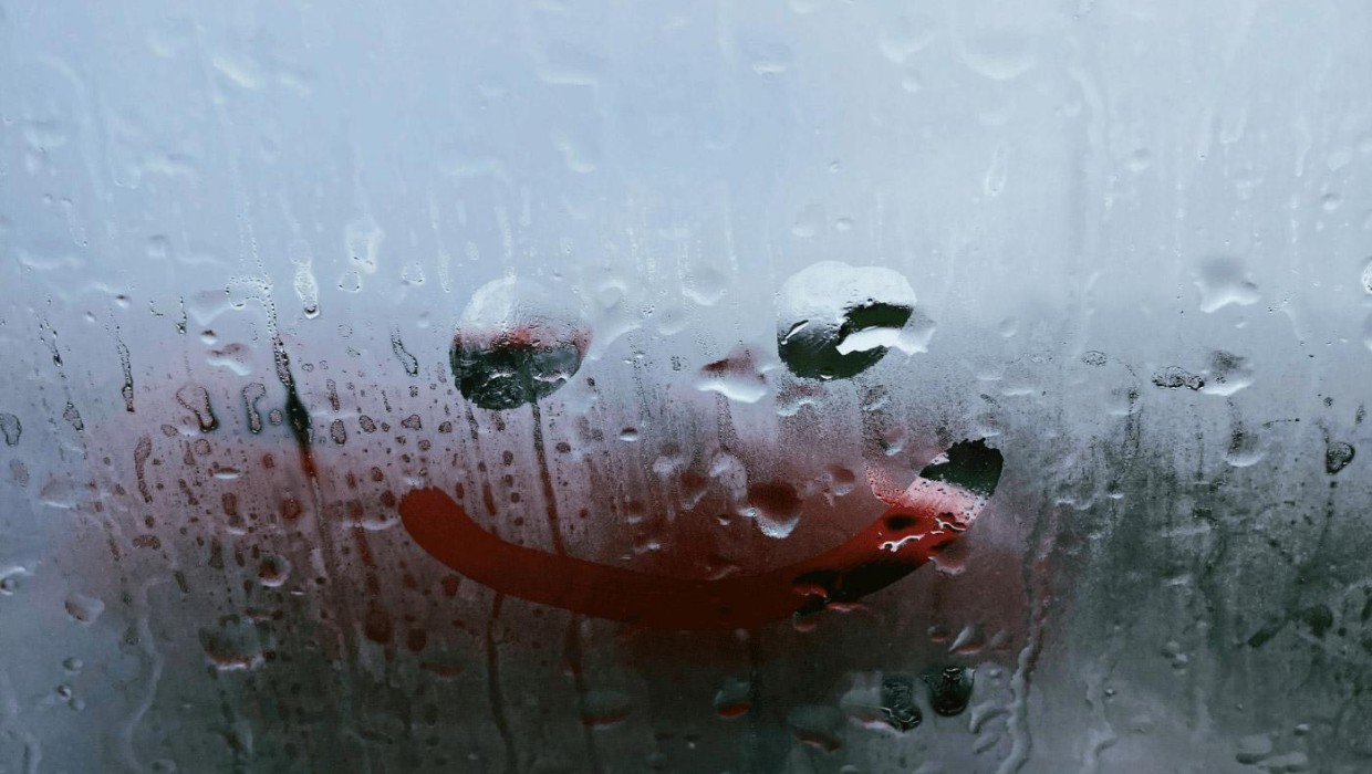 A smiley face drawn in fog symbolizes 10 PUTO car wash beliefs about cleanliness and luck.