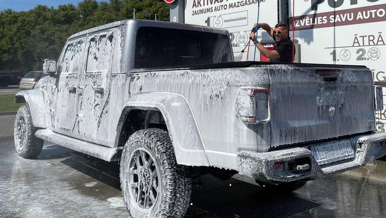 Pickup truck being washed with foam at PUTO self-service car wash.