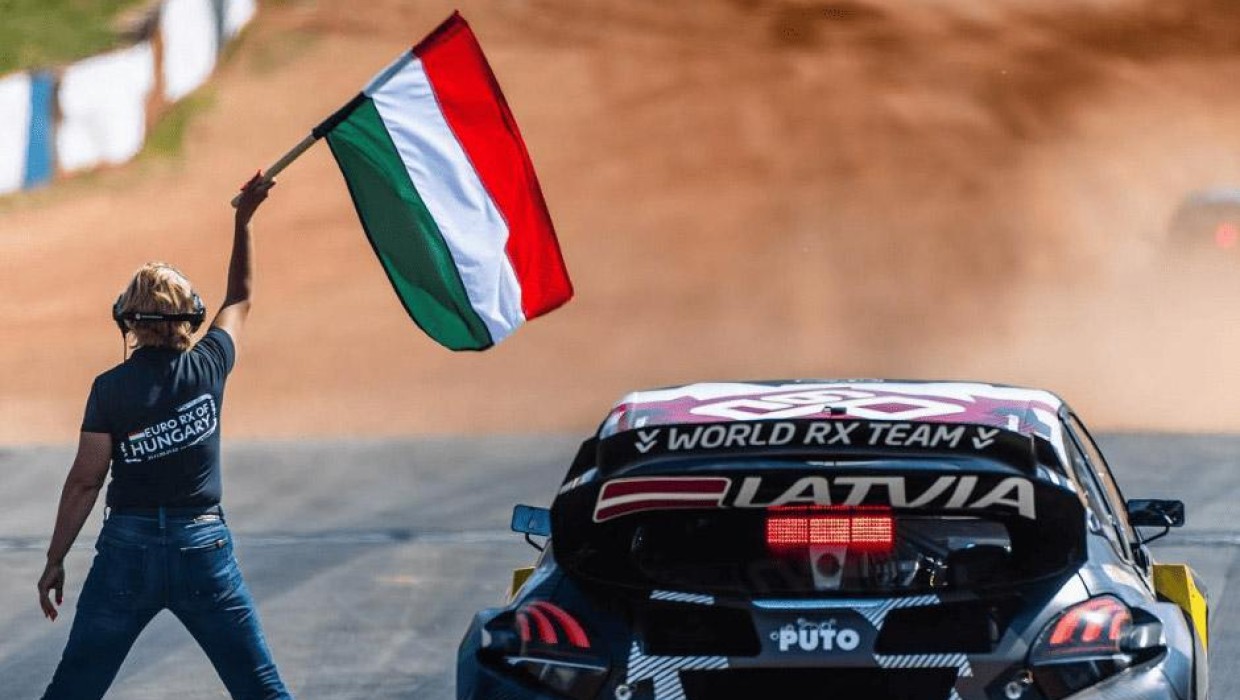 Latvian motorsport team PUTO in a race with a starting flag.