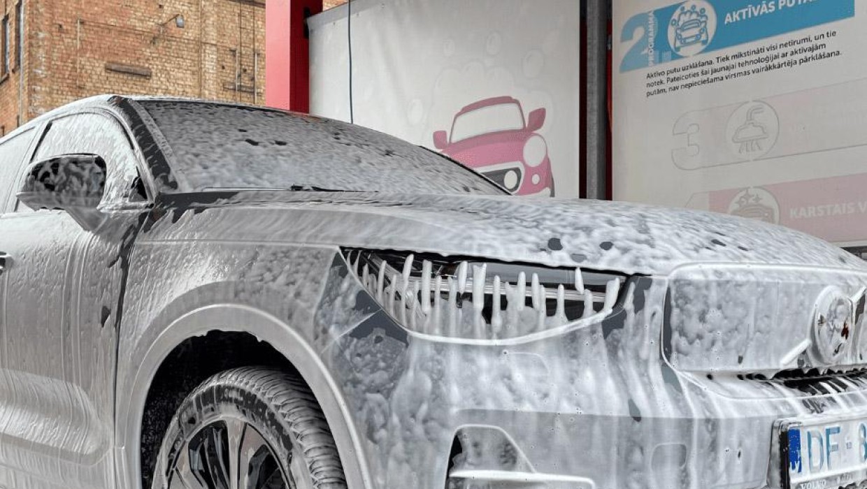 Car being washed with active foam at PUTO self-service car wash.