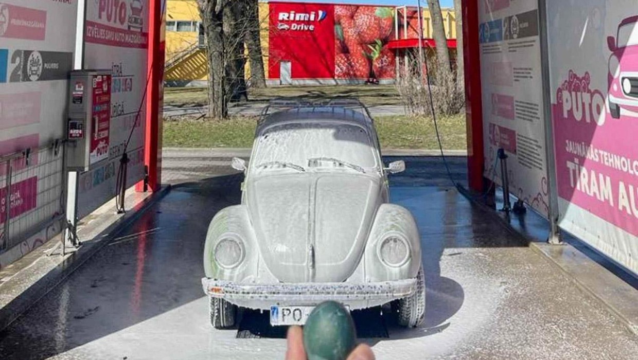 Car covered in foam at PUTO self-service car wash with a holiday egg in the foreground.